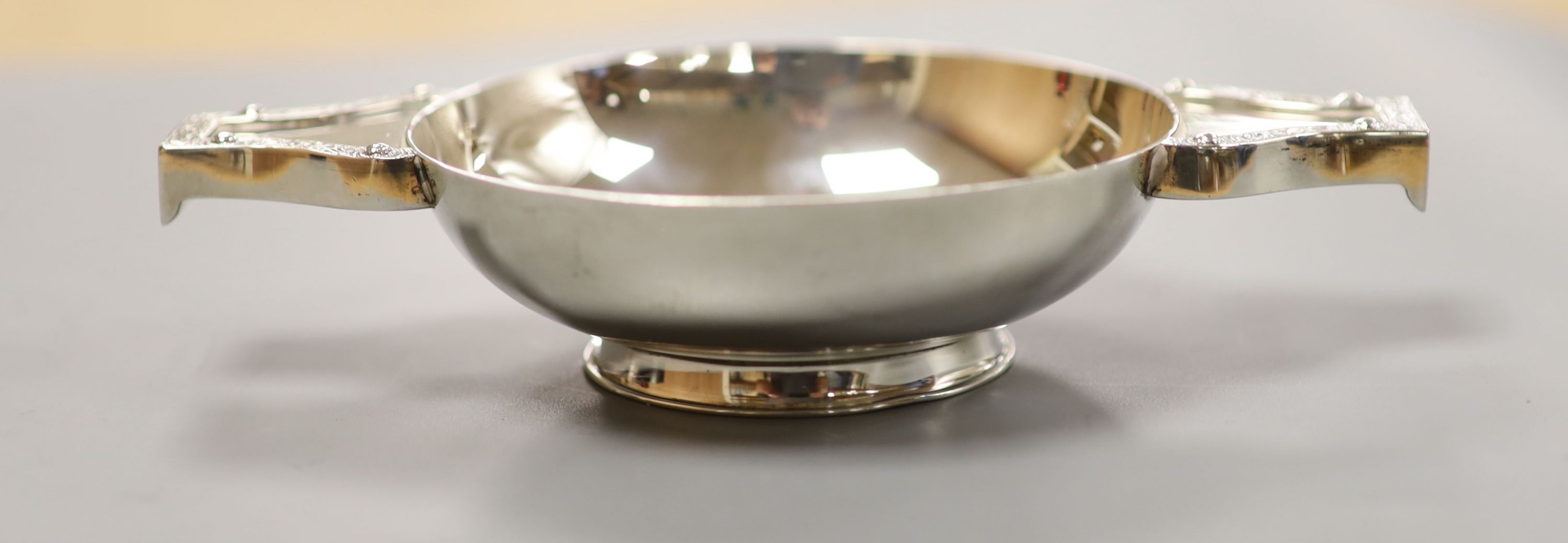 A cased pair of silver clothes brushes, silver quaich-type trophy and a George III silver dessert spoon.